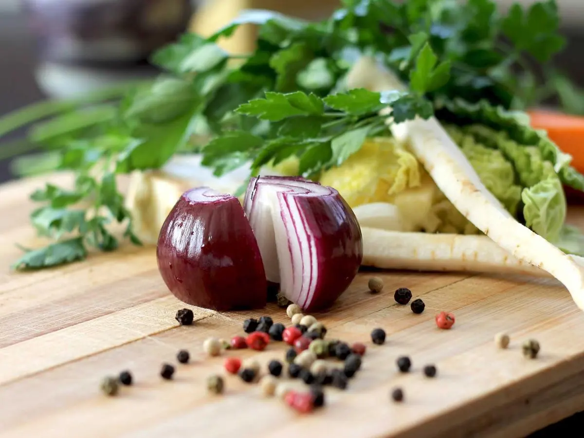 Freshly cut vegetables and herbs on a wooden board